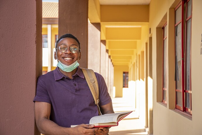 portrait-smiling-male-student-holding-book-smiling